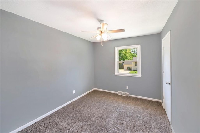 carpeted spare room with ceiling fan and baseboards