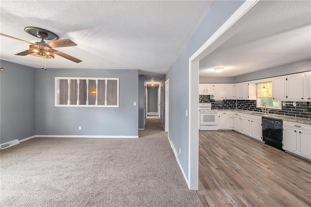 kitchen with electric range, dishwasher, a sink, a textured ceiling, and white cabinets