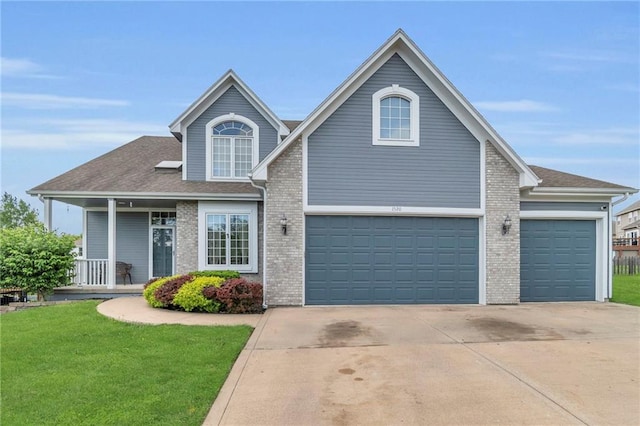 traditional-style home with a garage, covered porch, a front yard, brick siding, and driveway