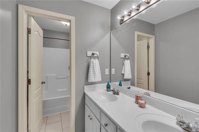 bathroom featuring a sink, tile patterned flooring, bathtub / shower combination, and double vanity