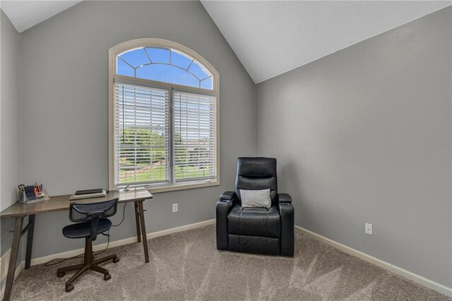 carpeted home office featuring baseboards and vaulted ceiling