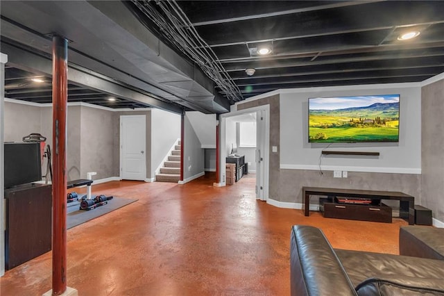 finished below grade area featuring baseboards and stairs