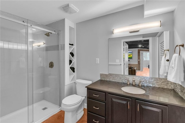 bathroom with vanity, toilet, a shower stall, ensuite bathroom, and visible vents