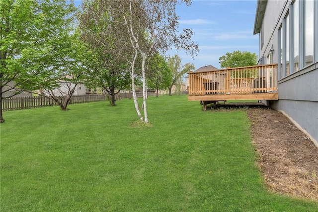 view of yard with fence and a wooden deck