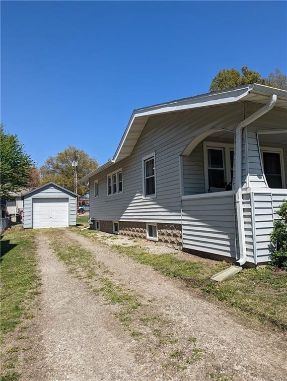 312 Kickapoo St, Hiawatha, KS 66434 - view of property exterior with a detached garage, driveway, and an outbuilding