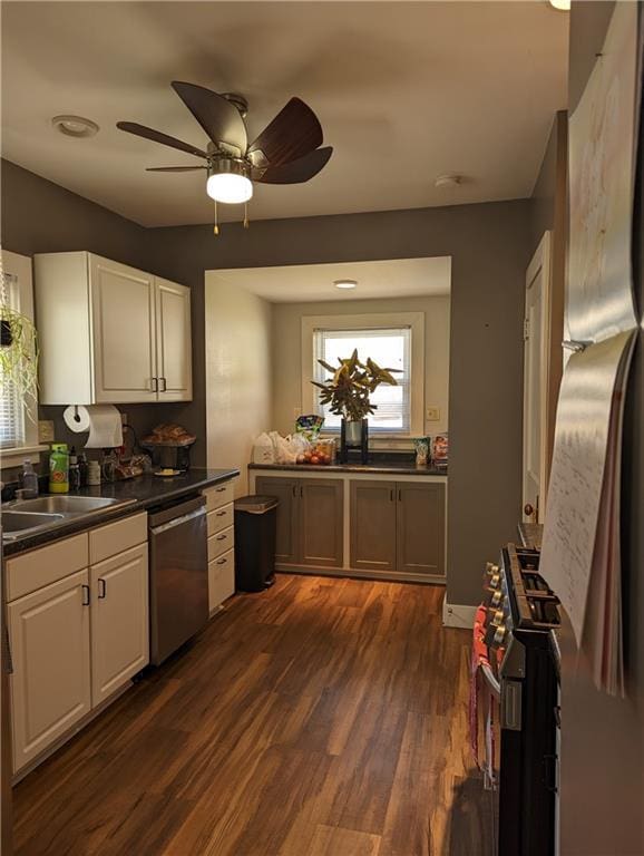 312 Kickapoo St, Hiawatha, KS 66434 - kitchen featuring dark countertops, dark wood-style flooring, white cabinetry, and stainless steel appliances