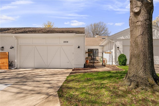 exterior space with a garage, brick siding, driveway, and a chimney