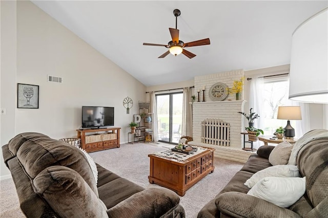 living area with a healthy amount of sunlight, visible vents, ceiling fan, and carpet floors