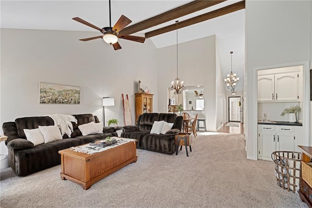 living area featuring beam ceiling, high vaulted ceiling, light carpet, and ceiling fan with notable chandelier