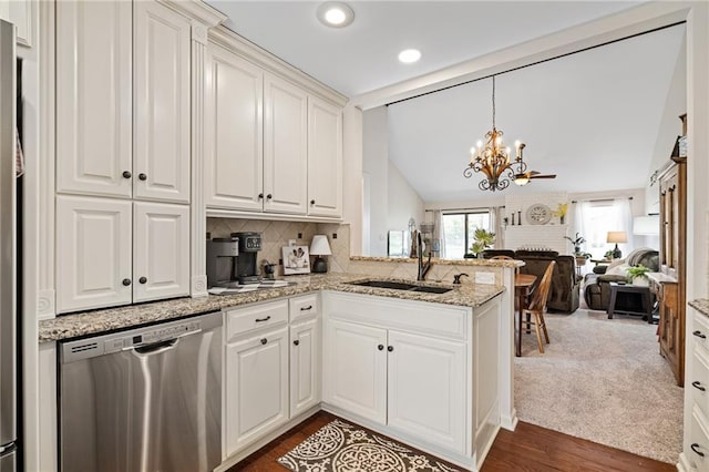 kitchen featuring a notable chandelier, a sink, open floor plan, stainless steel dishwasher, and vaulted ceiling with beams