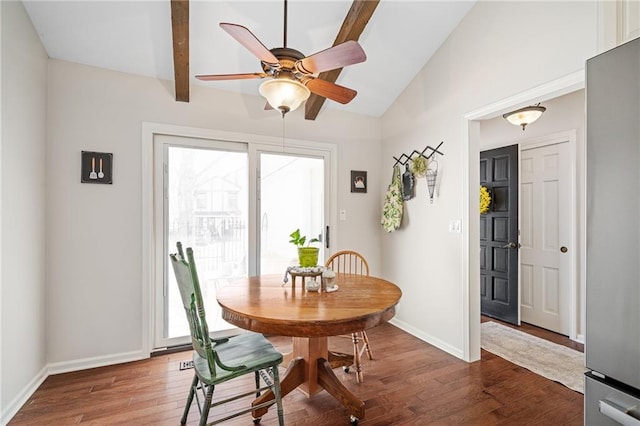 dining room featuring baseboards, wood finished floors, lofted ceiling with beams, and a ceiling fan