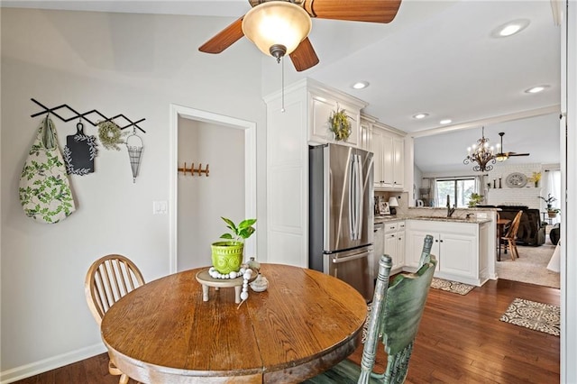 dining room featuring dark wood finished floors, recessed lighting, baseboards, and ceiling fan with notable chandelier