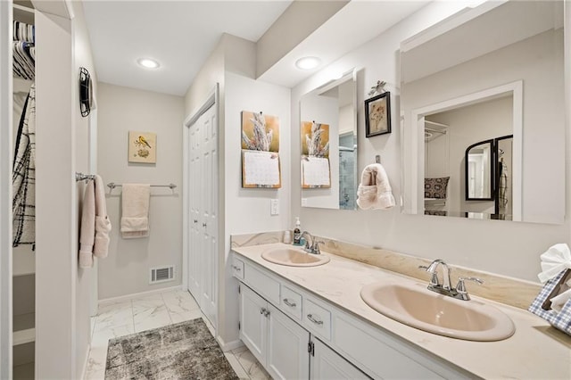 bathroom featuring baseboards, marble finish floor, a sink, and visible vents