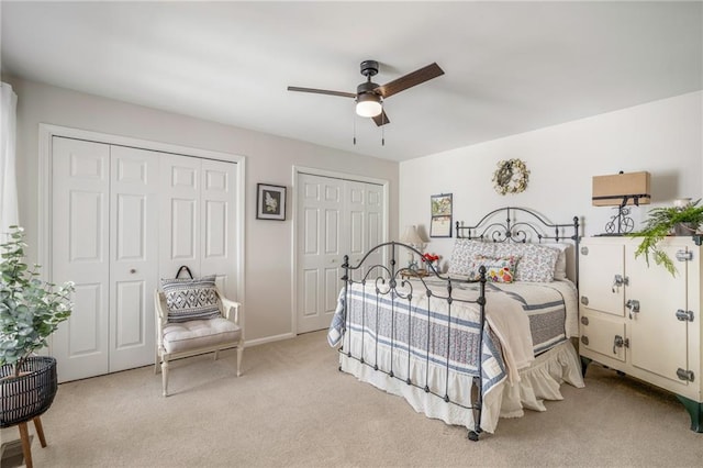 bedroom featuring multiple closets, a ceiling fan, and carpet floors