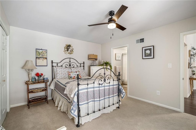 bedroom featuring visible vents, baseboards, ensuite bathroom, ceiling fan, and carpet