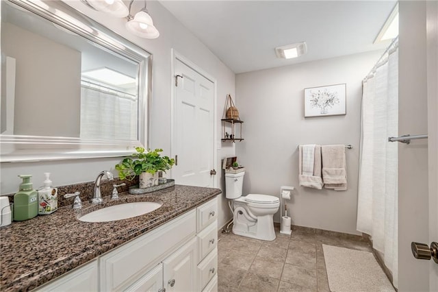 bathroom with toilet, baseboards, and vanity