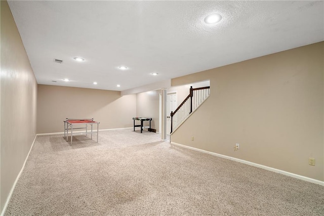 interior space with carpet flooring, baseboards, visible vents, and stairs