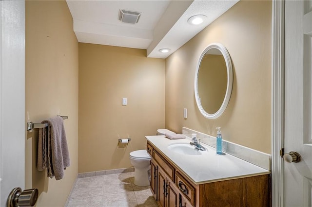 bathroom featuring vanity, baseboards, tile patterned floors, toilet, and visible vents