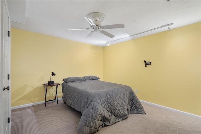 bedroom with baseboards, ceiling fan, and carpet