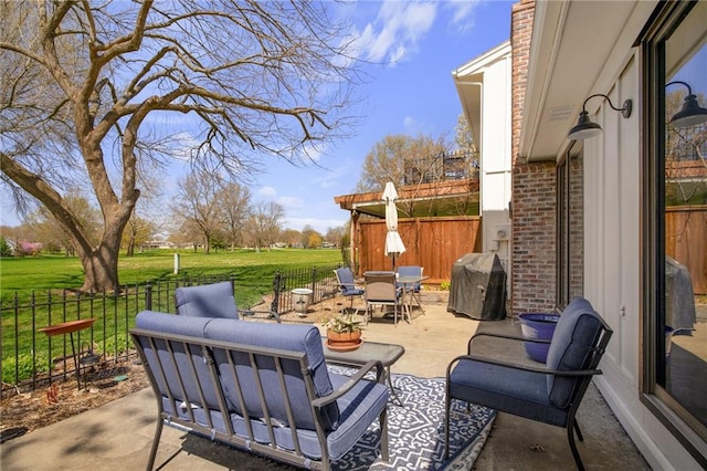 view of patio featuring grilling area, outdoor lounge area, and a fenced backyard