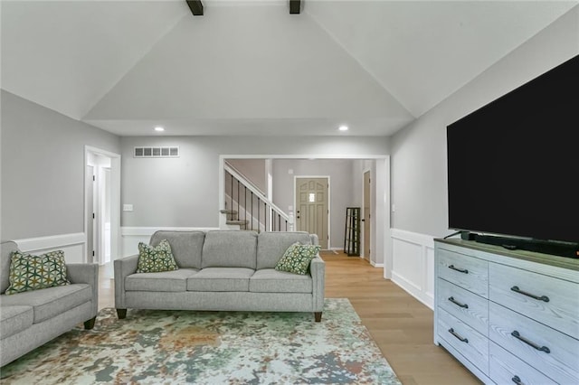 222 Chippewa Ln, Lake Winnebago, MO 64034 - living room featuring light wood-style floors, stairway, a wainscoted wall, recessed lighting, and a decorative wall