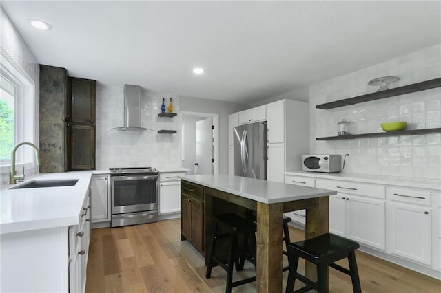 222 Chippewa Ln, Lake Winnebago, MO 64034 - kitchen featuring appliances with stainless steel finishes, open shelves, wall chimney range hood, backsplash, and light countertops