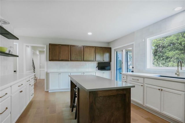 222 Chippewa Ln, Lake Winnebago, MO 64034 - kitchen with open shelves, light countertops, tasteful backsplash, a center island, and recessed lighting