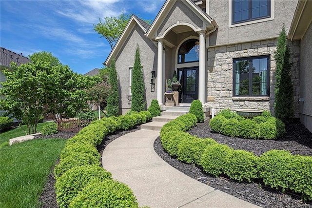 entrance to property with stucco siding and stone siding