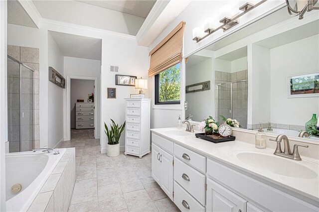 bathroom featuring visible vents, a sink, a garden tub, and a shower stall
