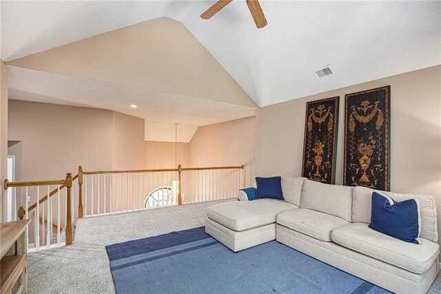 carpeted living area featuring visible vents, a ceiling fan, and high vaulted ceiling