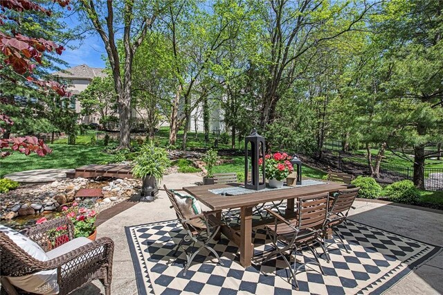 view of patio with fence and outdoor dining area