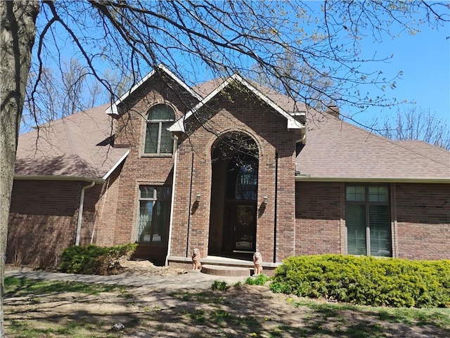 724 Village Dr, Girard, KS 66743 - view of front of home featuring brick siding and a shingled roof