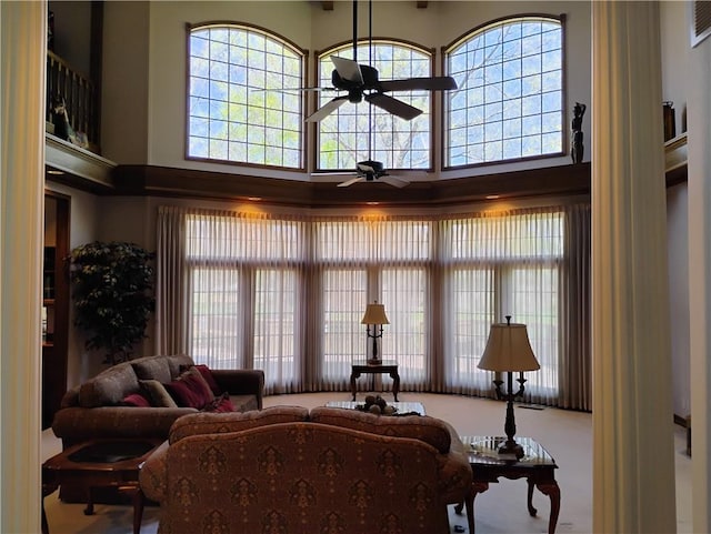 724 Village Dr, Girard, KS 66743 - living area with a ceiling fan, a towering ceiling, and healthy amount of natural light