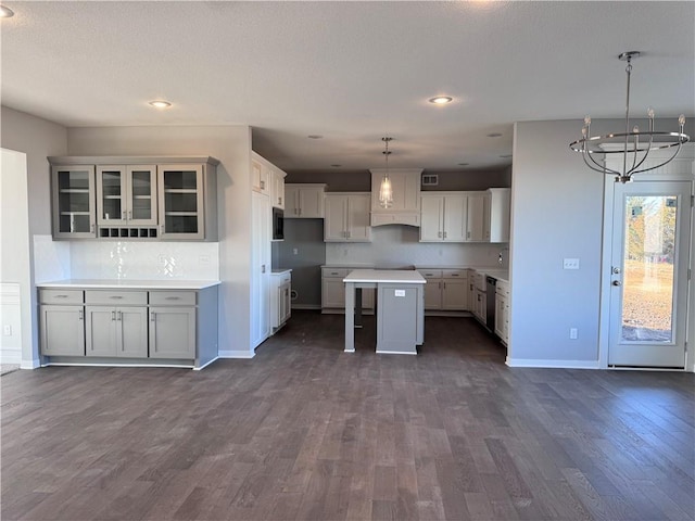 11432 S Langley St, Olathe, KS 66061 - kitchen featuring dark wood-type flooring, a kitchen island, baseboards, and stainless steel appliances