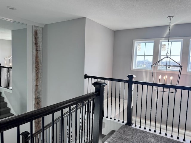 11432 S Langley St, Olathe, KS 66061 - hallway featuring an upstairs landing, a notable chandelier, and a textured ceiling