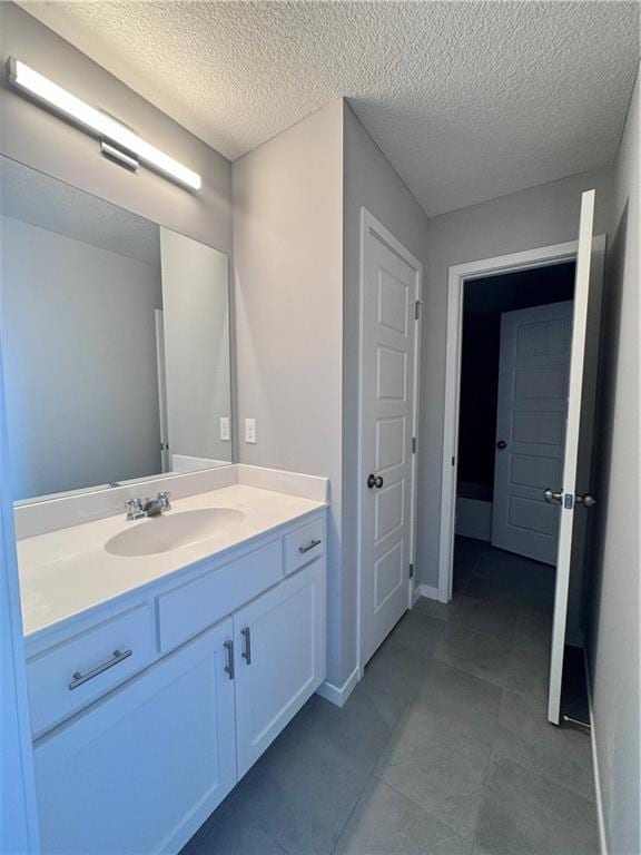 11432 S Langley St, Olathe, KS 66061 - bathroom featuring baseboards, vanity, and a textured ceiling