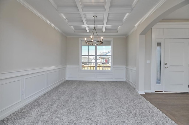 11448 S Langley St, Olathe, KS 66061 - empty room with crown molding, beamed ceiling, arched walkways, coffered ceiling, and a notable chandelier
