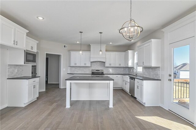 11448 S Langley St, Olathe, KS 66061 - kitchen with an inviting chandelier, dark countertops, recessed lighting, tasteful backsplash, and stainless steel appliances