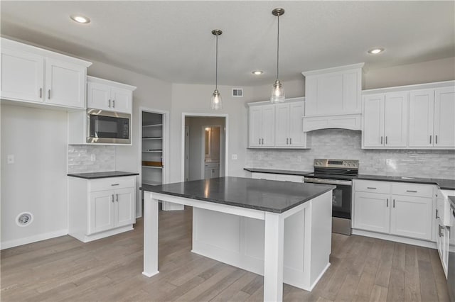 11448 S Langley St, Olathe, KS 66061 - kitchen featuring light wood-style floors, dark countertops, stainless steel appliances, and white cabinetry
