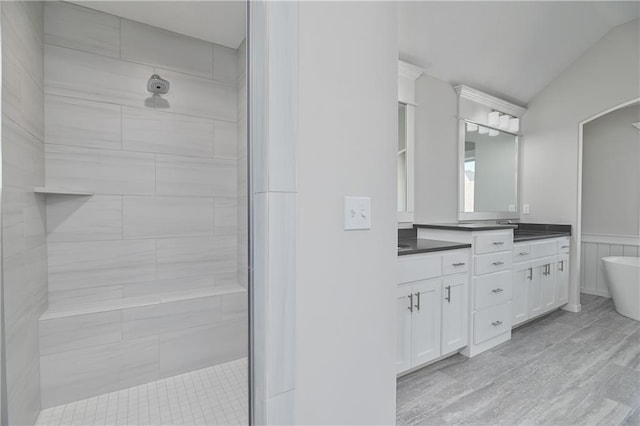 11448 S Langley St, Olathe, KS 66061 - full bathroom featuring double vanity, a freestanding tub, vaulted ceiling, and a tile shower