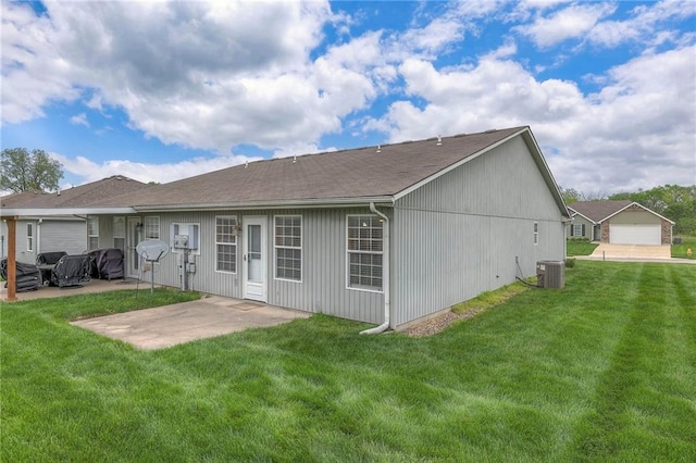back of house featuring a lawn, central air condition unit, and a patio area