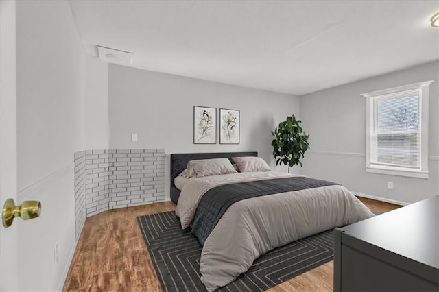 2130 E 83rd St, Kansas City, MO 64132 - bedroom featuring baseboards and wood finished floors