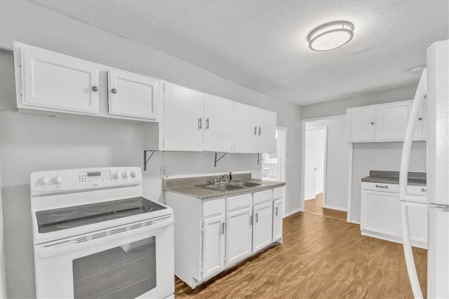 2130 E 83rd St, Kansas City, MO 64132 - kitchen featuring white cabinets, white appliances, a sink, and wood finished floors