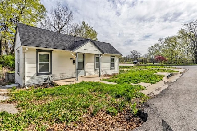 2130 E 83rd St, Kansas City, MO 64132 - bungalow with stone siding and roof with shingles