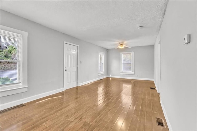2130 E 83rd St, Kansas City, MO 64132 - unfurnished room with visible vents, a ceiling fan, and wood finished floors