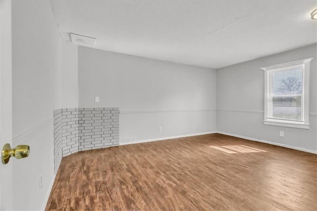 2130 E 83rd St, Kansas City, MO 64132 - unfurnished room featuring baseboards and wood finished floors