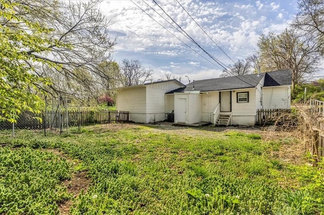 2130 E 83rd St, Kansas City, MO 64132 - back of property featuring entry steps, fence, and a yard