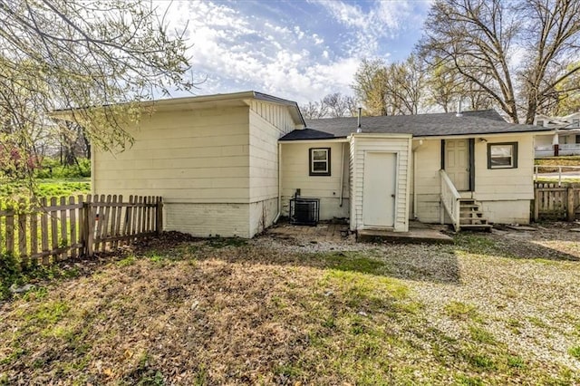 2130 E 83rd St, Kansas City, MO 64132 - rear view of property featuring central air condition unit, entry steps, and fence