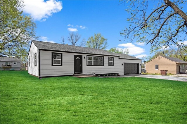 ranch-style house featuring a shingled roof, concrete driveway, a front yard, and a garage