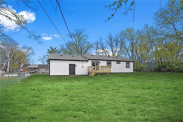 back of house featuring a yard, fence, and a deck